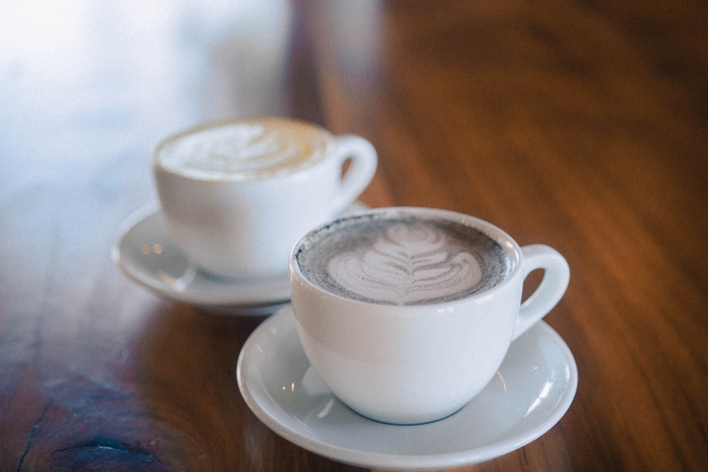 two white ceramic coffee cup and saucer