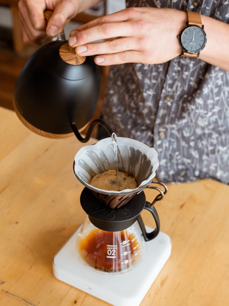 Barista carefully pouring a latte with precision