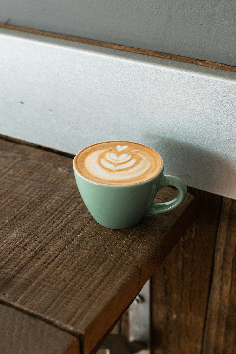 cappuccino in green ceramic mug