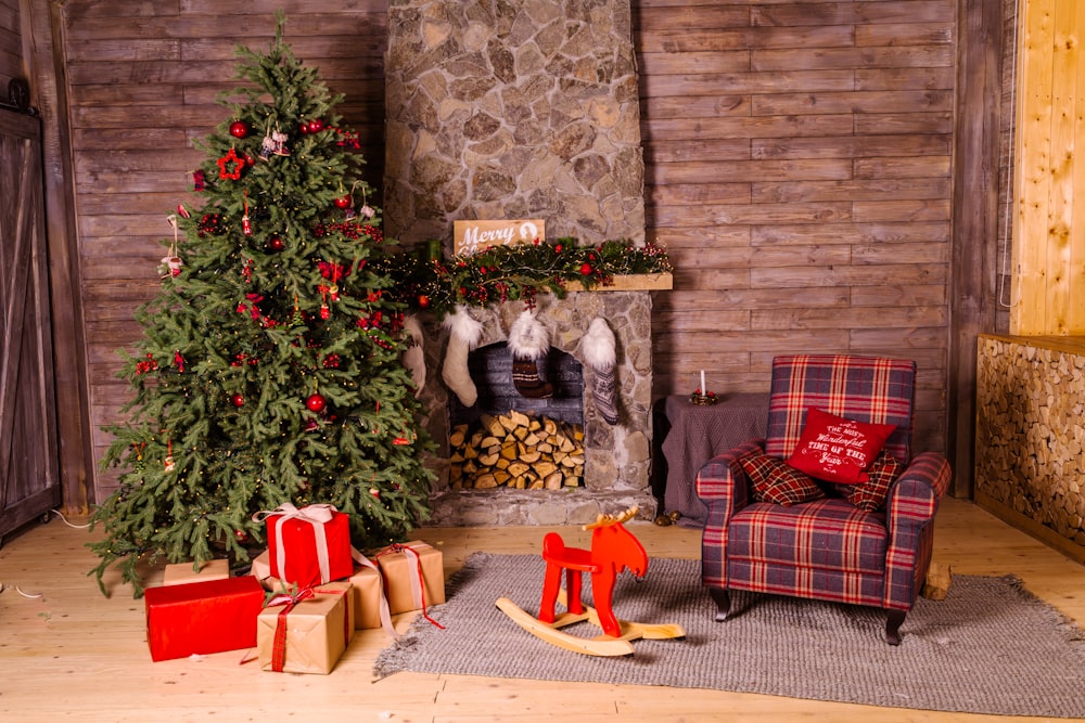 green Christmas tree beside red and brown fabric sofa chair