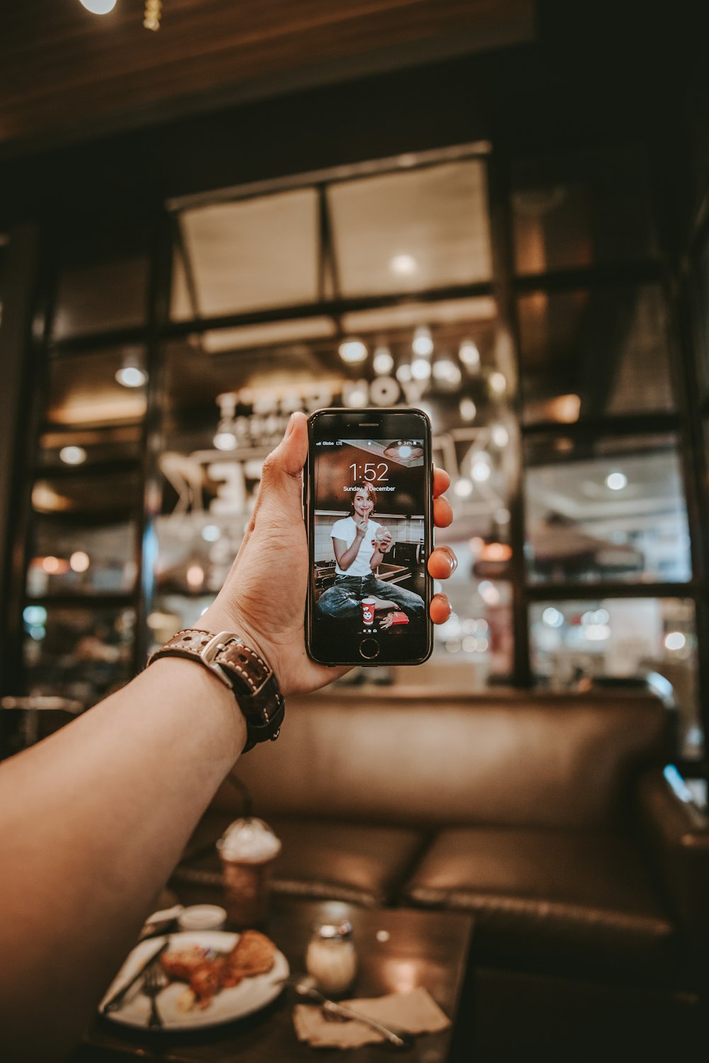 selective focus photography of right person's hand holding turned-on iPhone