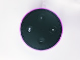 2nd gen. black and purple Amazon Echo Dot on white surface