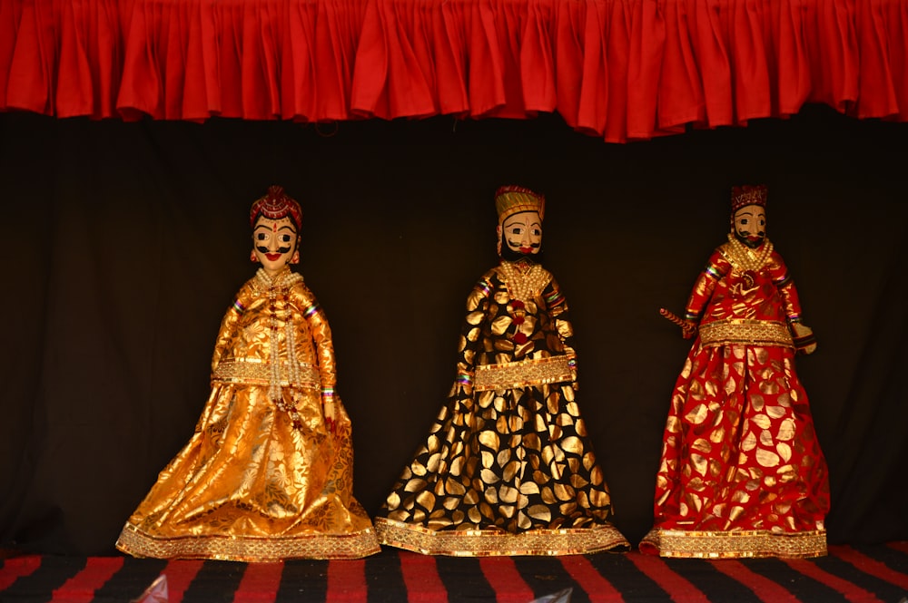 three assorted dolls in dresses