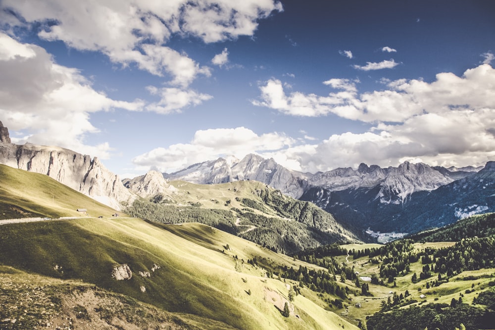 mountains and hills under clouds