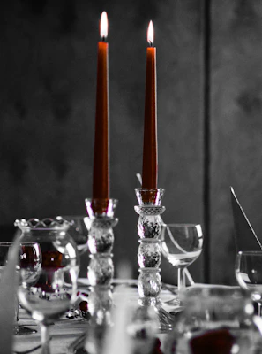 Elegant candle holders casting gentle shadows on a marble-topped table.