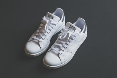 pair of white low-top sneakers shoe zoom background