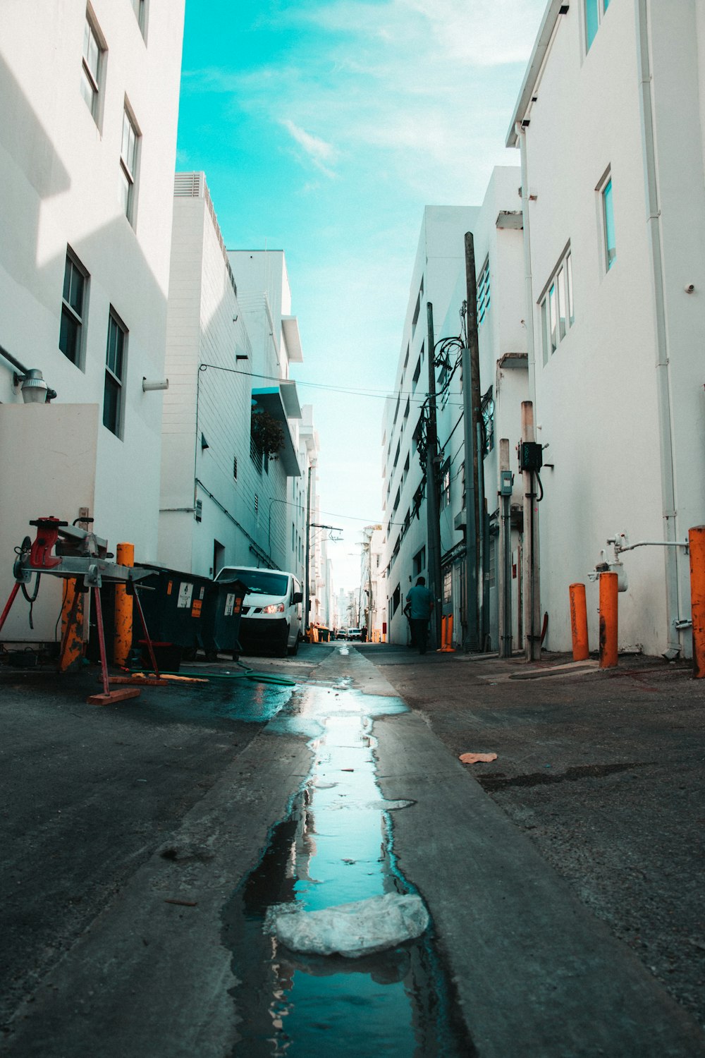 white vehicle beside white buildihng