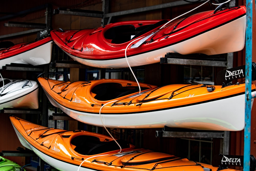 assorted color kayaks on shelf