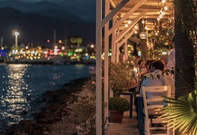 Couple enjoying a candlelight dinner by the sea.
