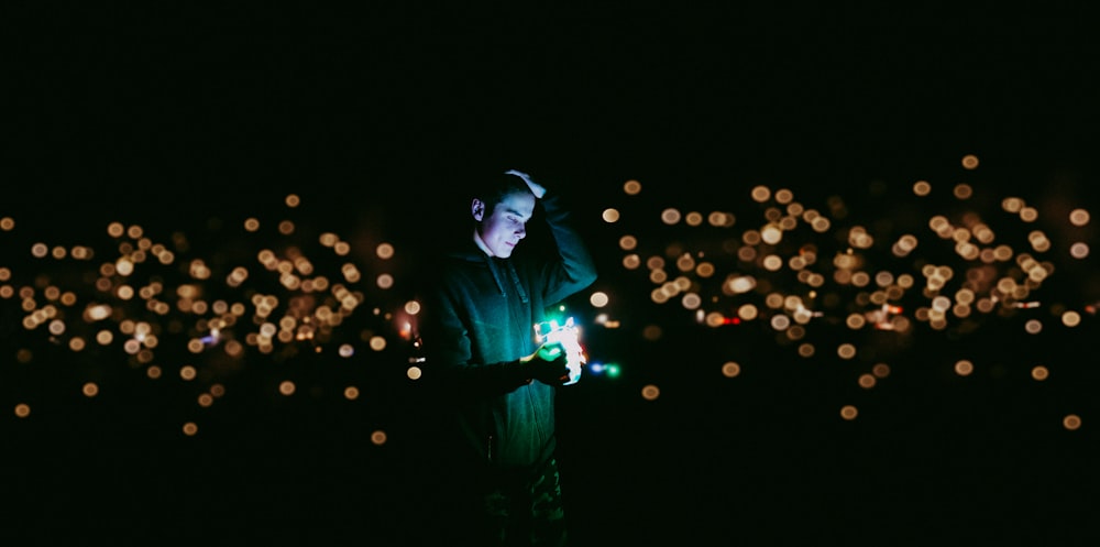 man holding green light