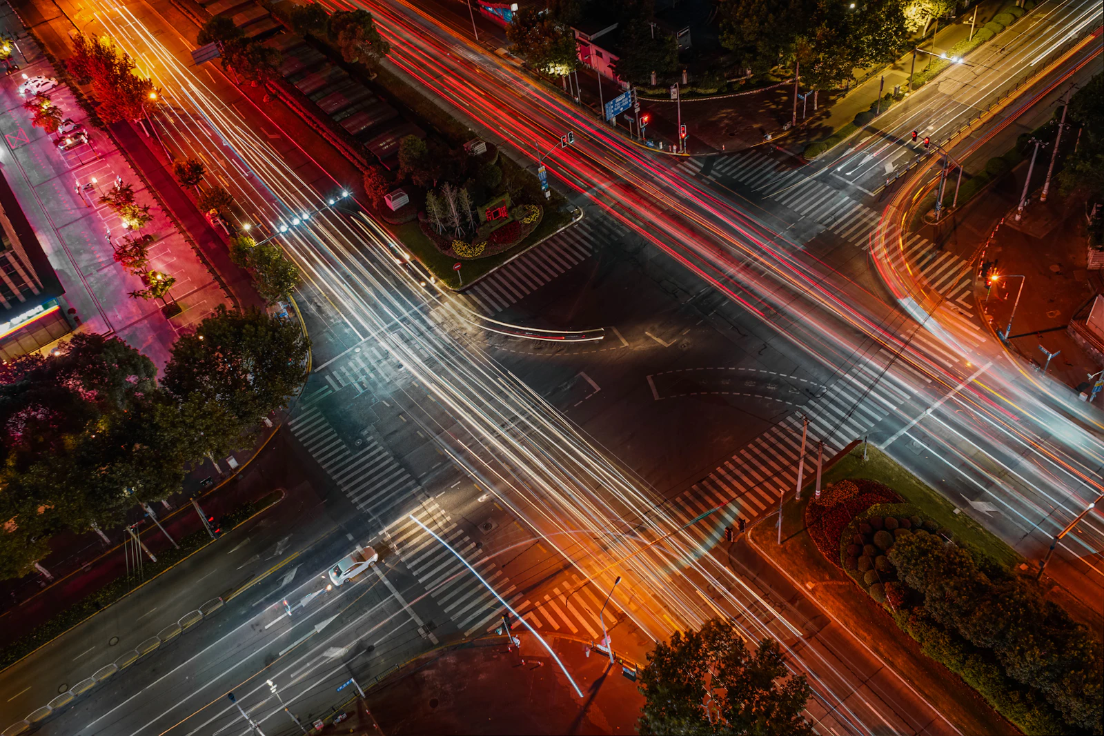 Long-exposure photograph of traffic at a night-time crossroad, representing the choice point a 301 or 302 redirect creates