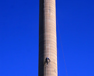 A friendly technician in uniform cleaning a chimney on a sunny day in Winter Haven.