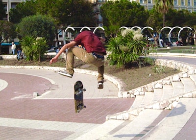 Slow-motion capture of a skateboarder performing a trick in an empty park.