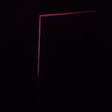 A dark background with a thin, pink neon line forming an L-shape, creating a minimalist and modern aesthetic.