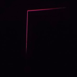 A dark background with a thin, pink neon line forming an L-shape, creating a minimalist and modern aesthetic.