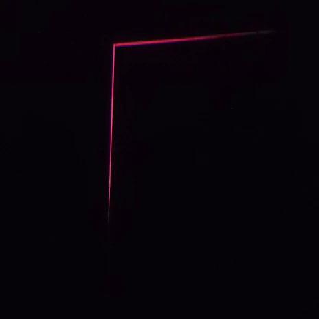 A bold, minimalist website layout featuring striking pink and red accents on black background.