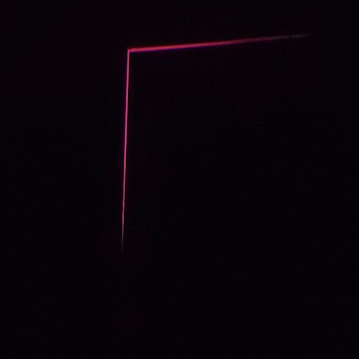 A dark background with a thin, pink neon line forming an L-shape, creating a minimalist and modern aesthetic.