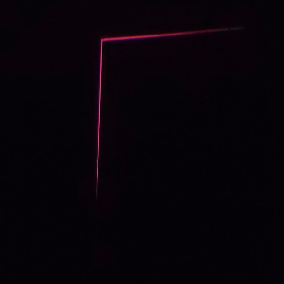A dark background with a thin, pink neon line forming an L-shape, creating a minimalist and modern aesthetic.