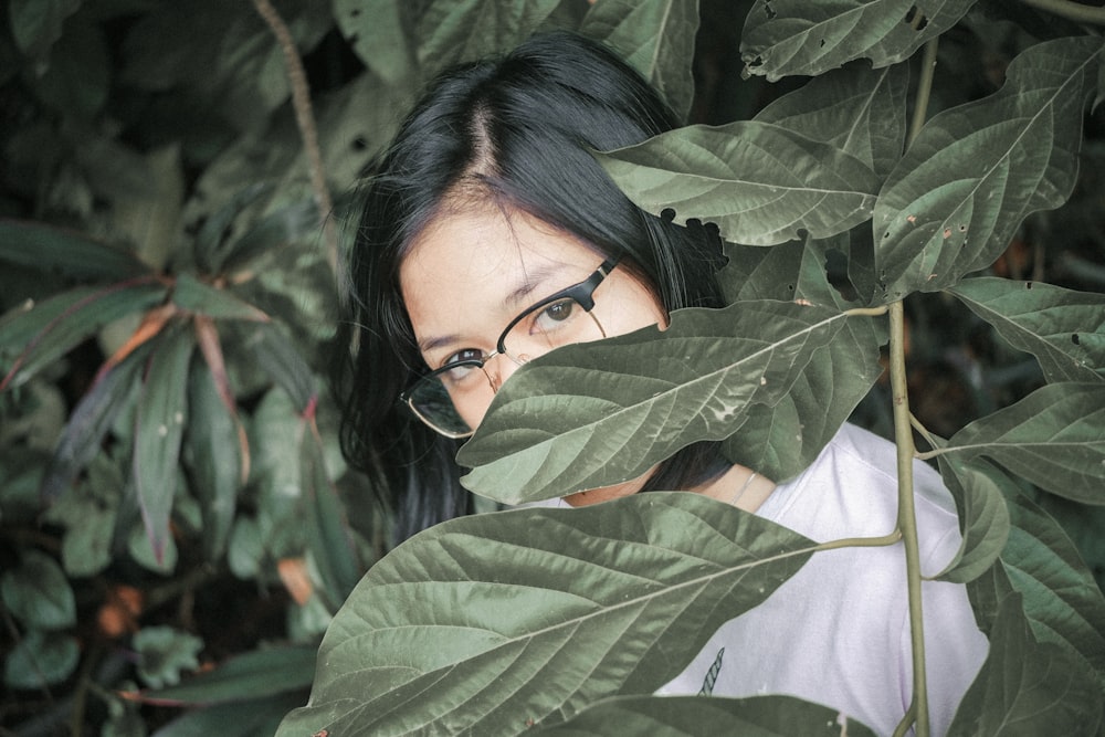 woman behind leaves