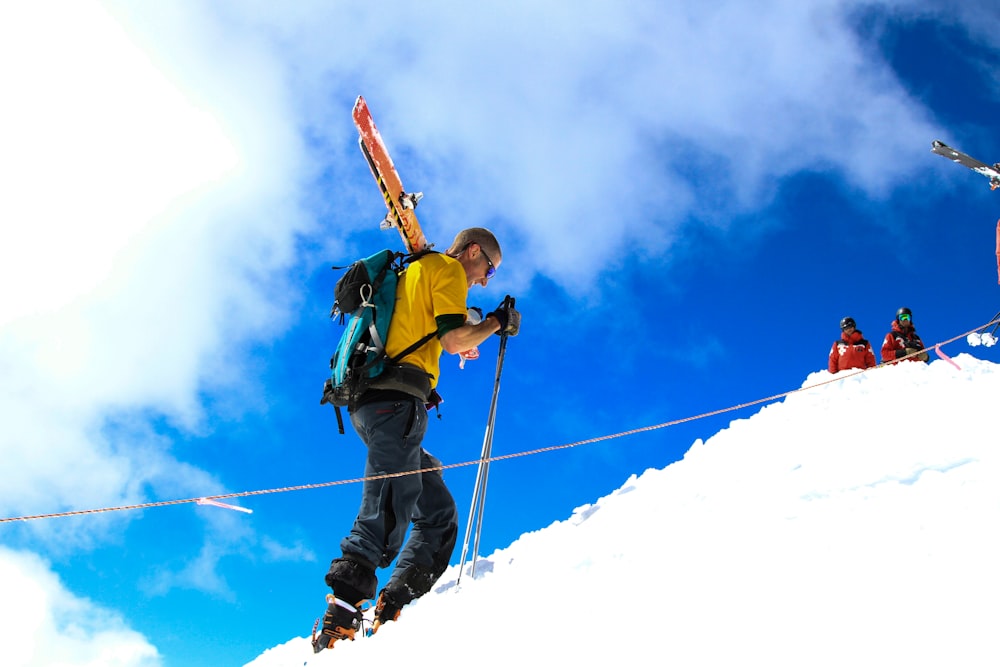 man climbing on snow mountain