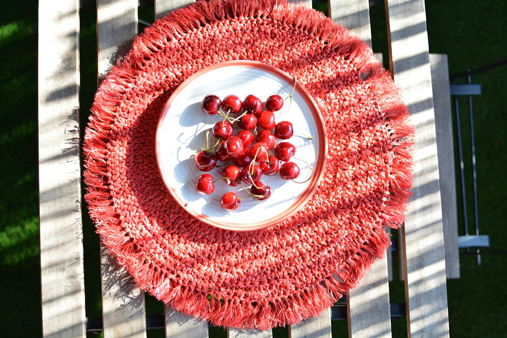 round red fruits on red area mat