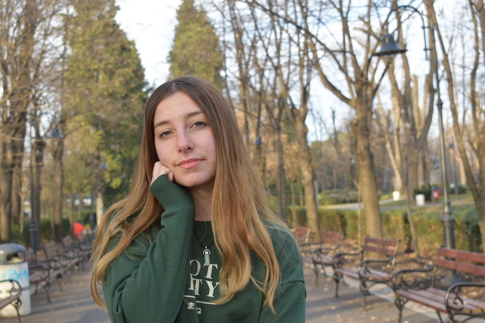 woman with green sweater in park