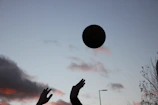 High-contrast silhouette of a player executing a perfect volley against a dramatic sunset sky.