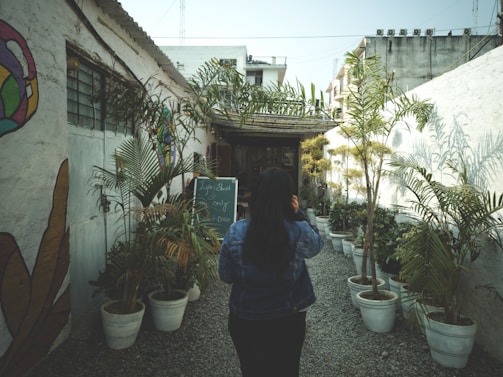 woman standing beside the house during daytime