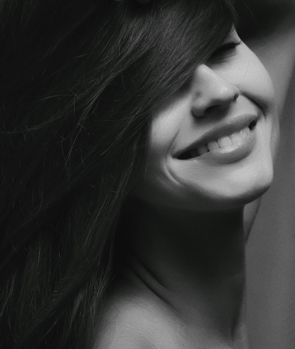 grayscale photography of smiling woman