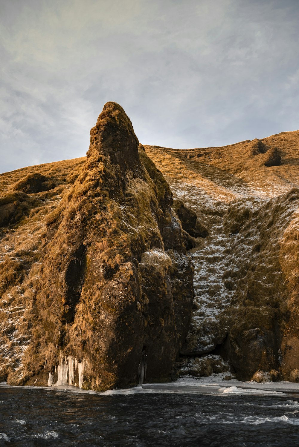 brown rock formation in beach