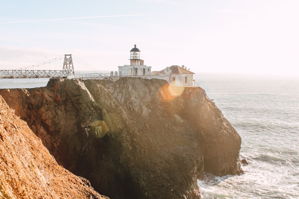 lighthouse near the ocean photography