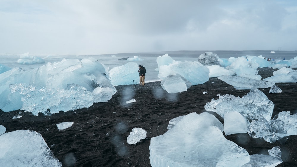 person standing surrounded with ice blocks