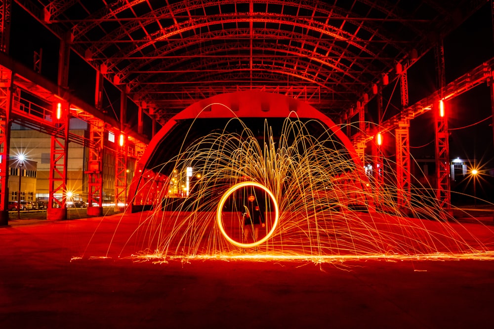 time lapse photography of person standing in front of fire display