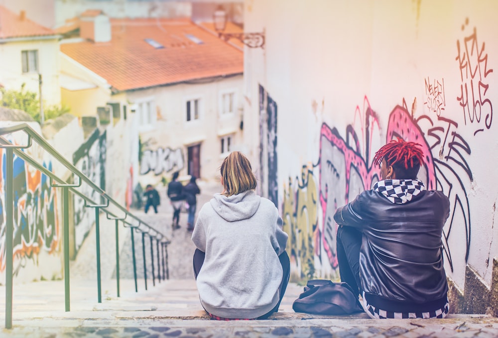 man and woman sitting on stairs