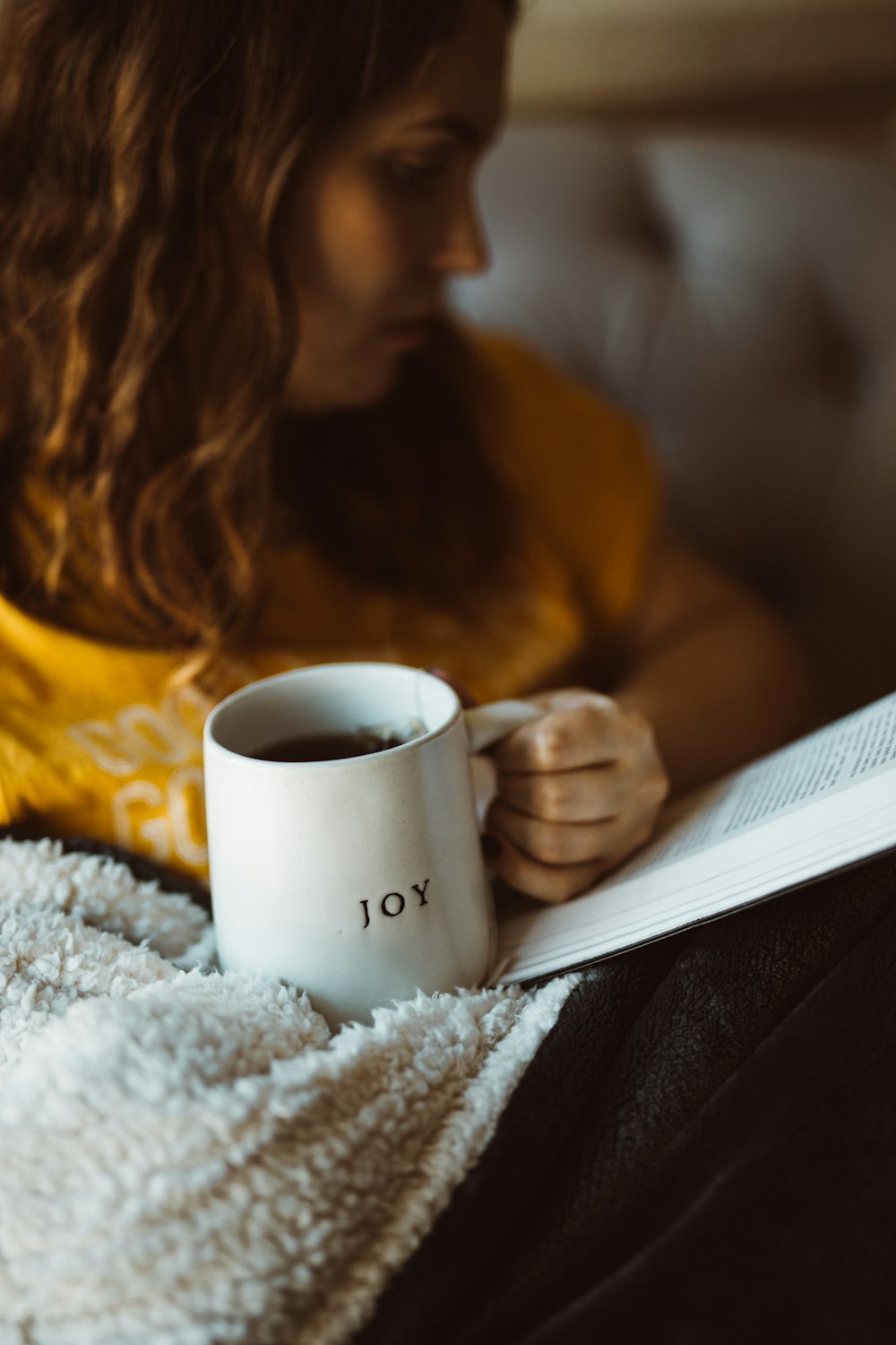 mujer sosteniendo taza blanca