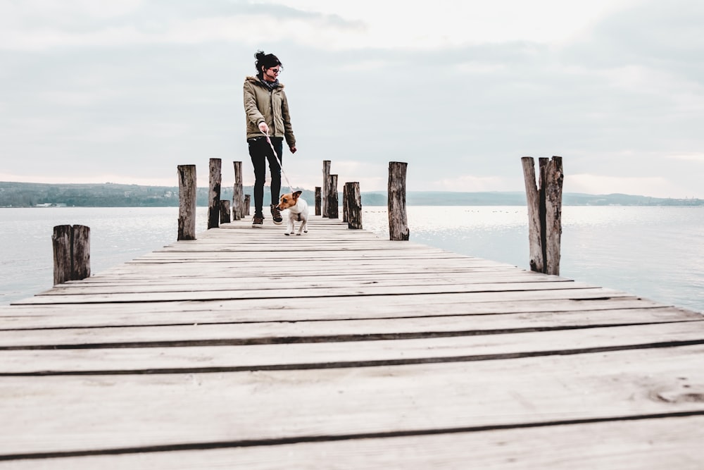 woman and dog on boardwalk