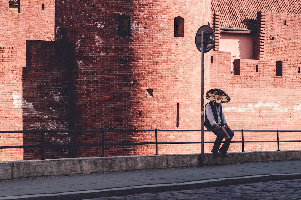 man sitting on metal rails