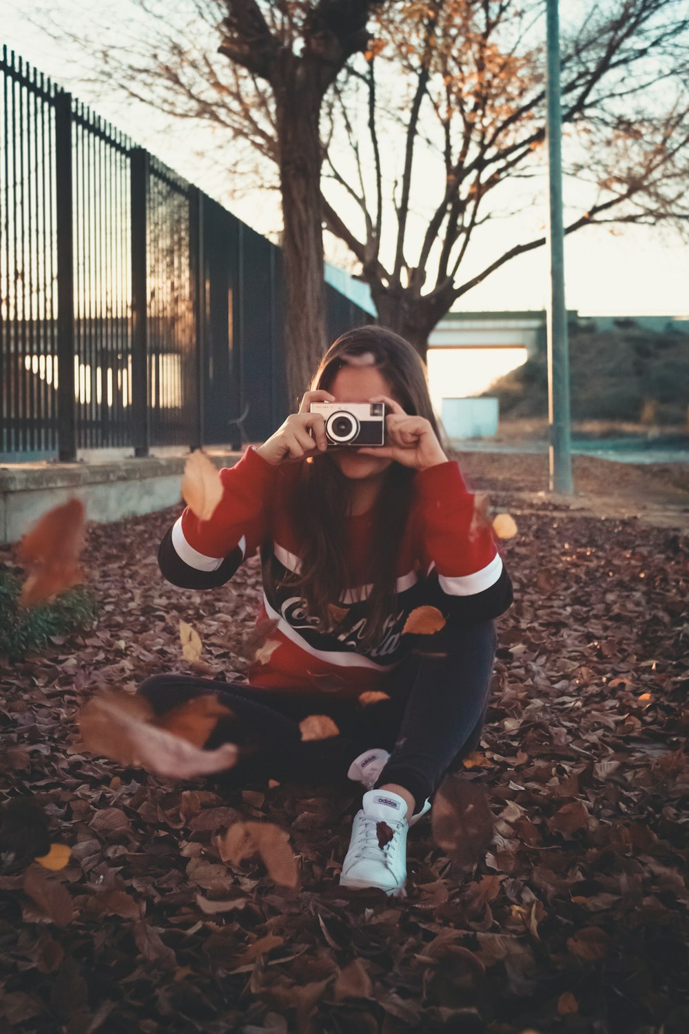 woman sitting while holding camera