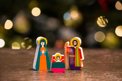the nativity figurine on table manger teams background