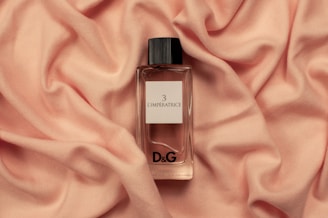 Dolce & Gabbana fragrance bottle on pink textile