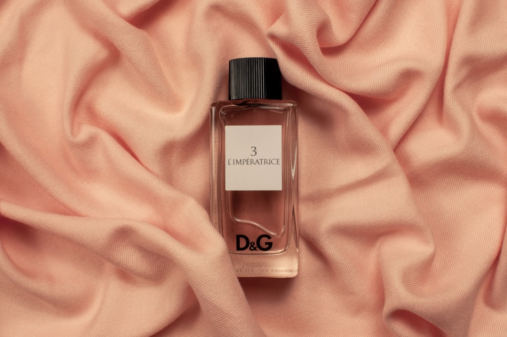 Dolce & Gabbana fragrance bottle on pink textile