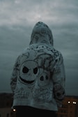 A sigil-etched hoodie displayed against a mystical backdrop.