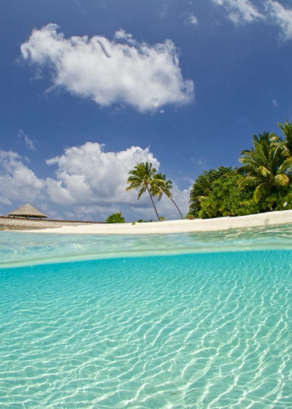 white clouds in blue sky over beach