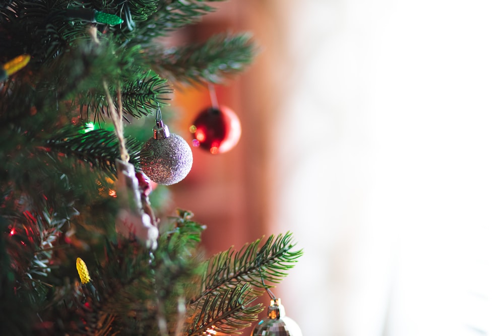 silver and red ornament on Christmas tree