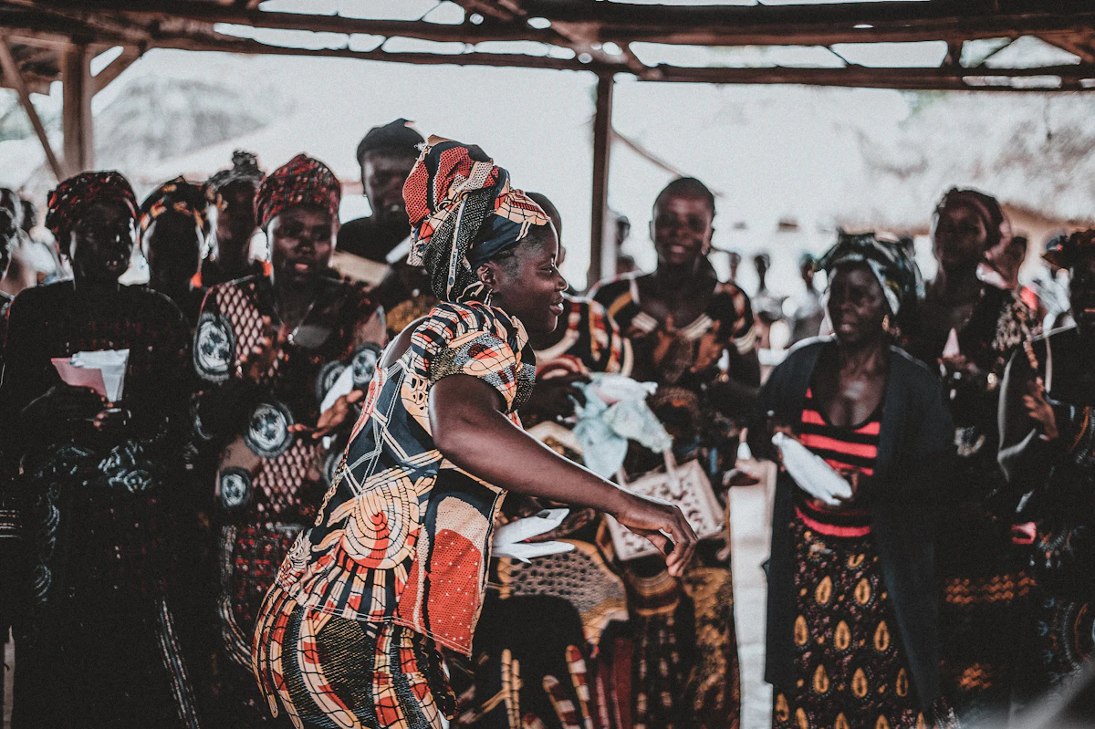 Friends in African print dancing together at a celebration