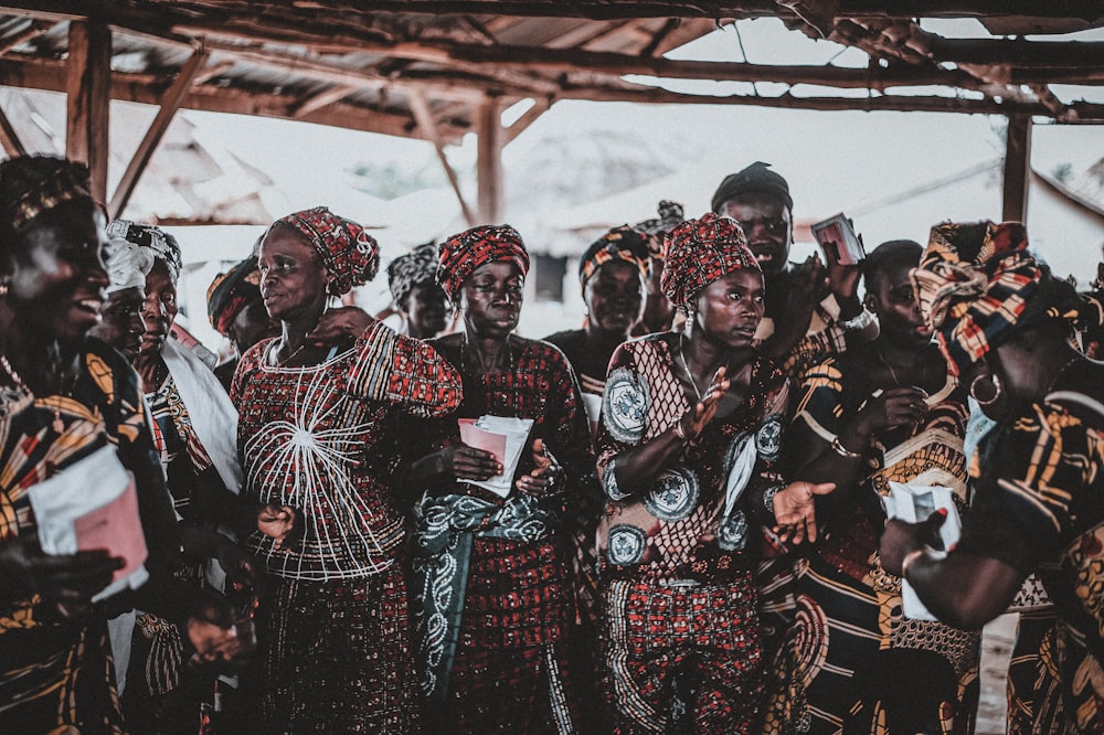 people wearing tribal outfit under cottage