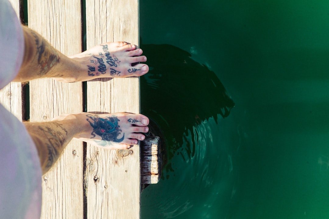 person standing on beige boardwalk