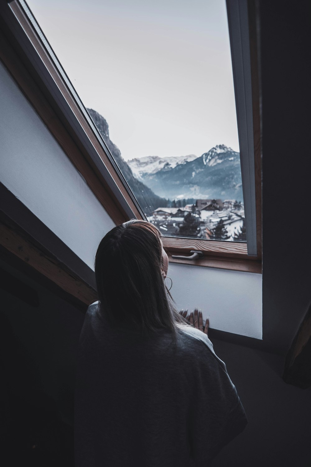 woman wearing white shirt front o window during daytime