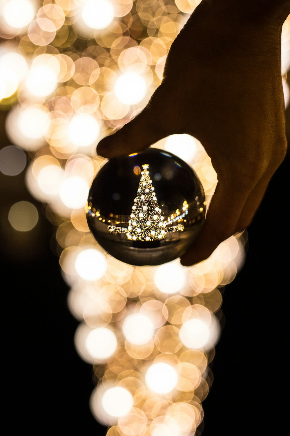 person holding glass bauble