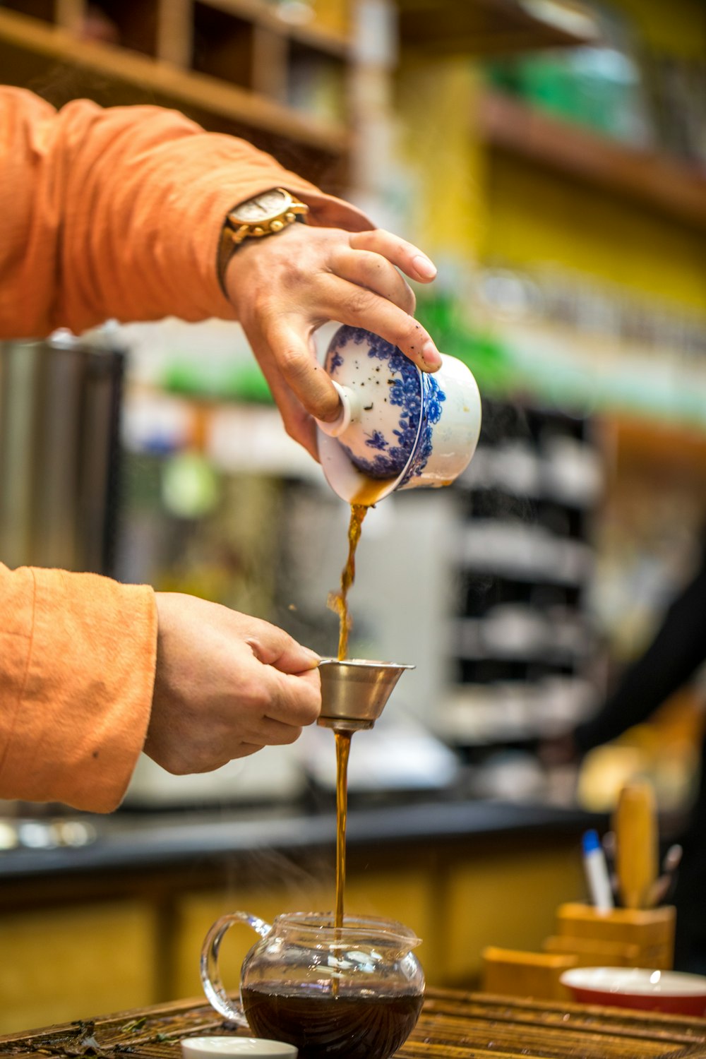 person pouring tea on cup